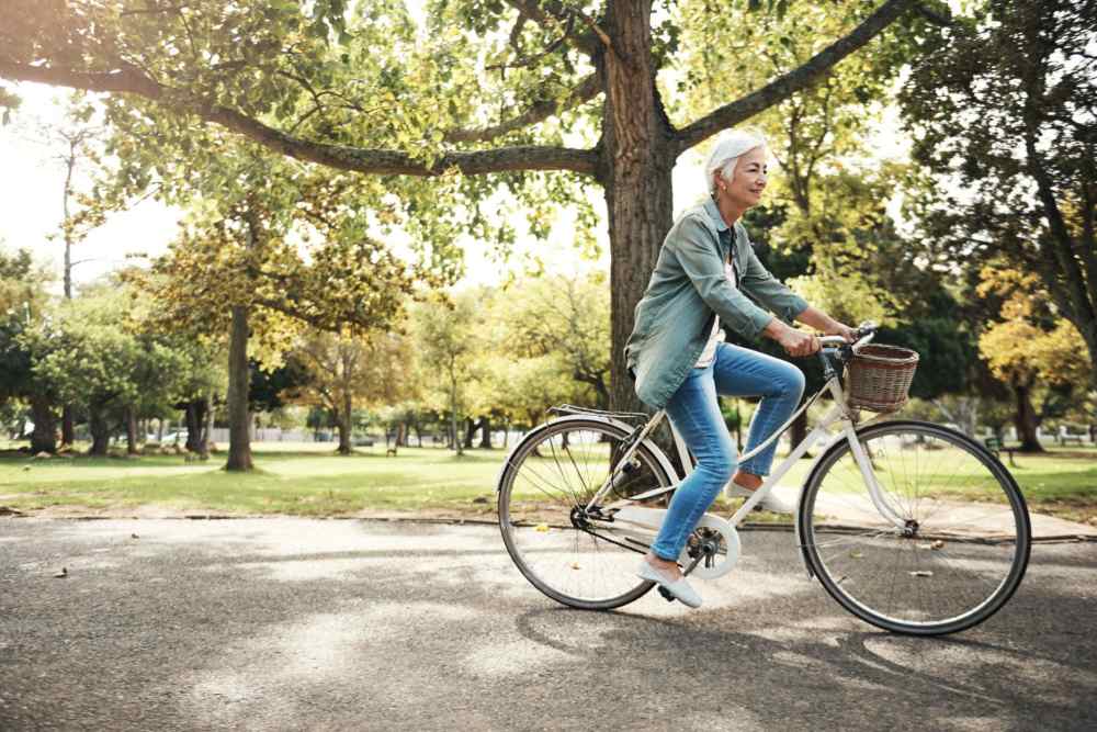 Senior woman enjoying a bike ride in a park