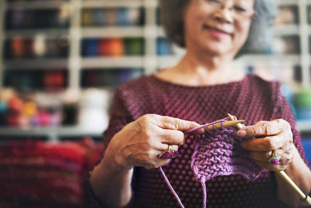 Senior resident enjoying a knitting activity