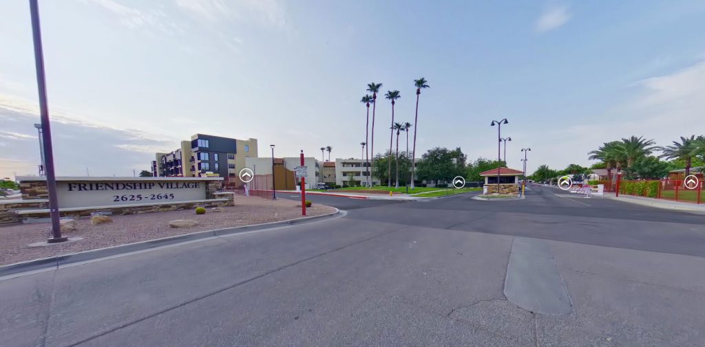 Entrance of Friendship Village Tempe with palm trees and signage