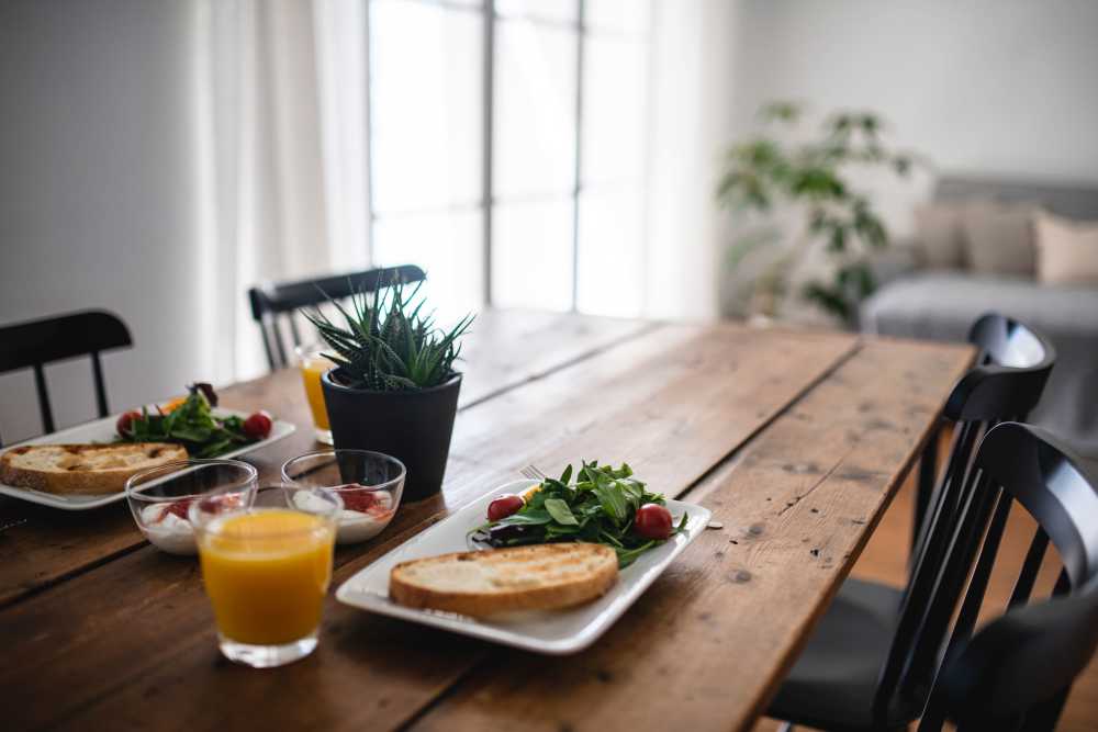 Breakfast table set with fresh food and drinks