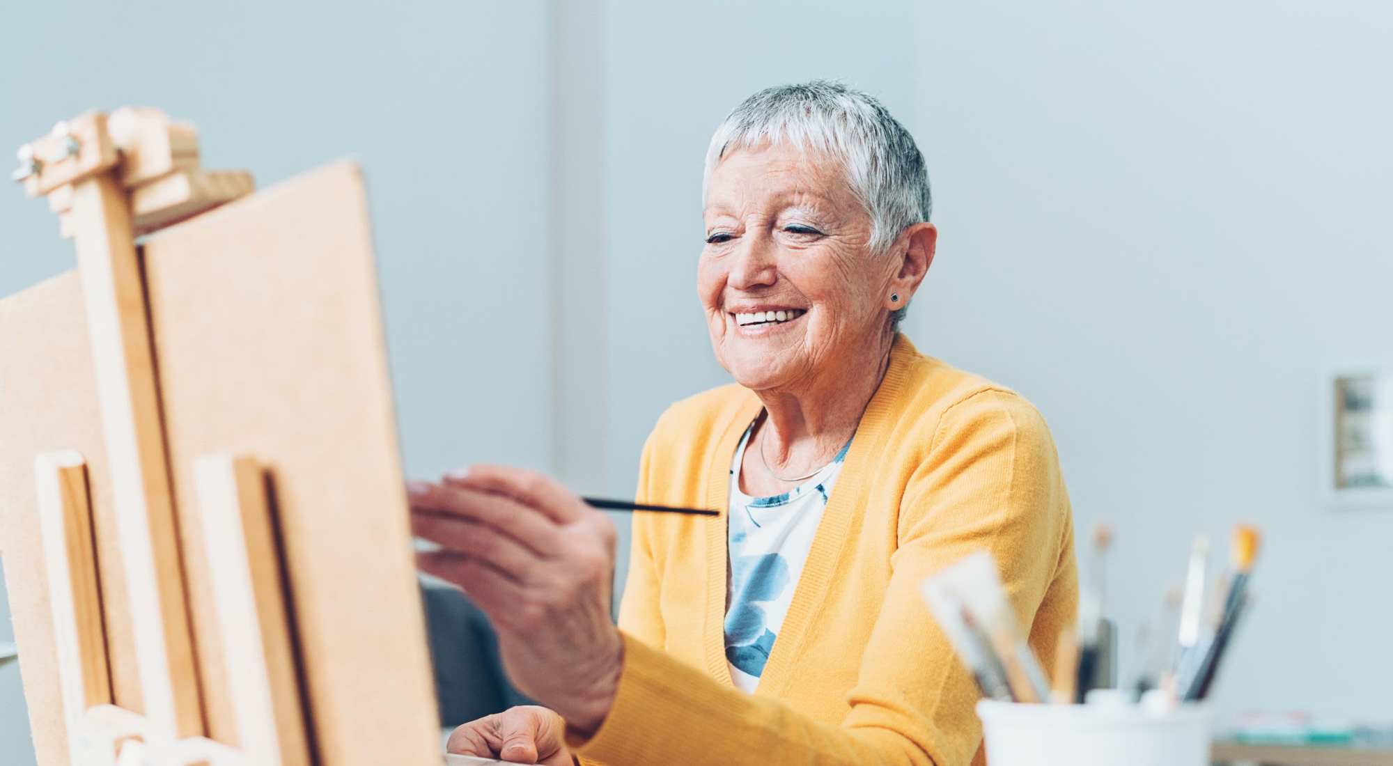 Senior woman painting in an art class