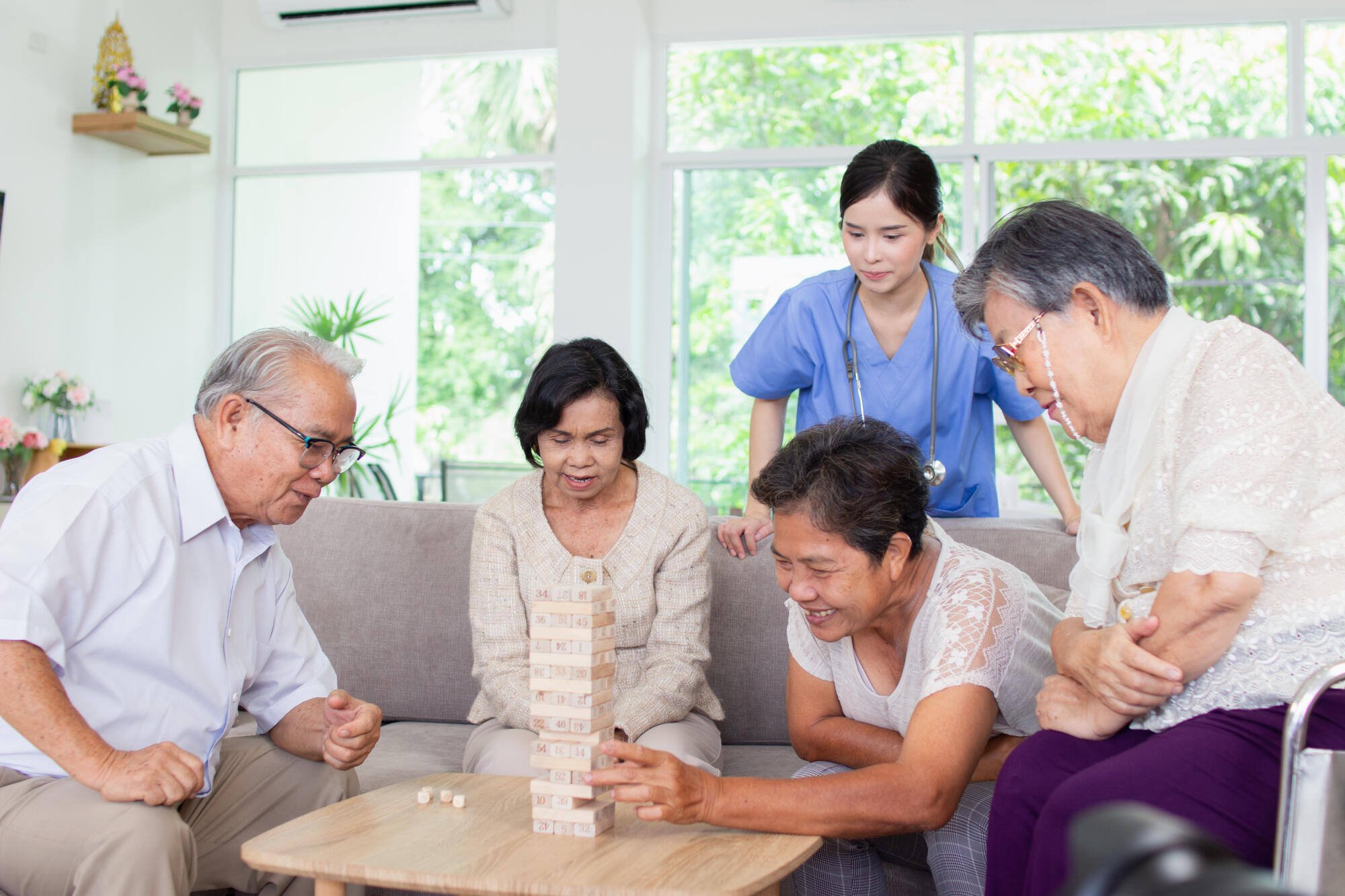 Residents and staff engaging in a game of Jenga