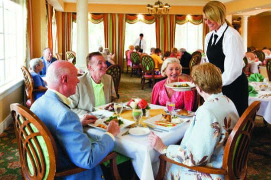 Residents dining together in a bright dining room