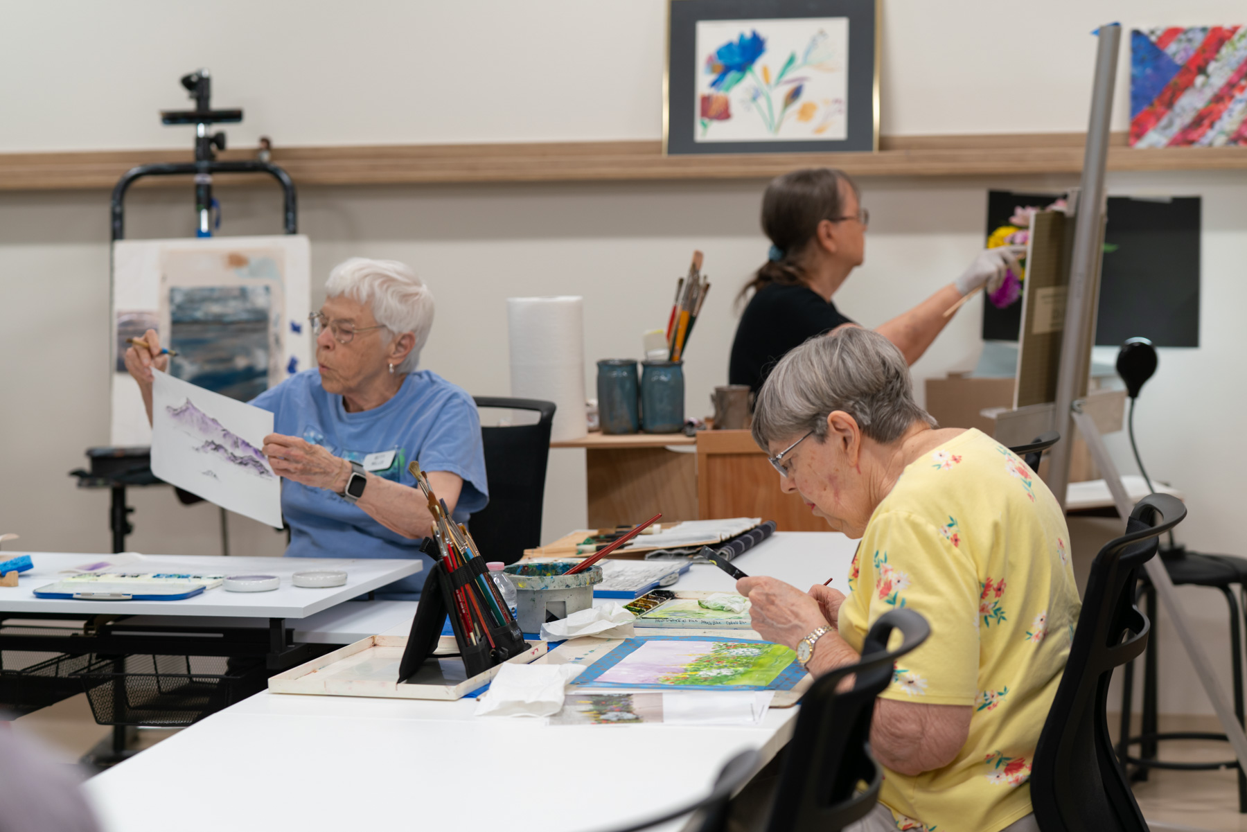 Residents engaging in an art class in a bright room