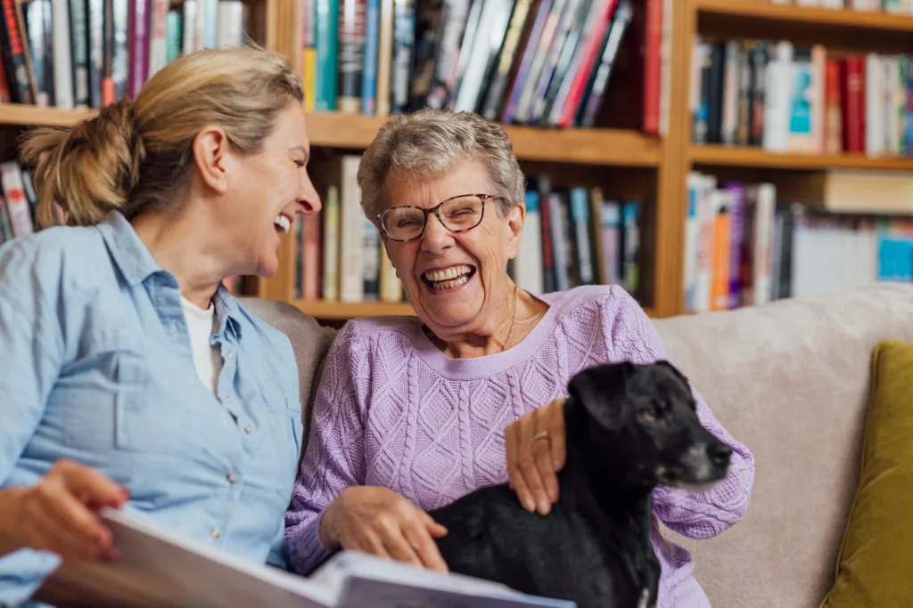 Residents enjoying a moment together with a dog in a cozy setting