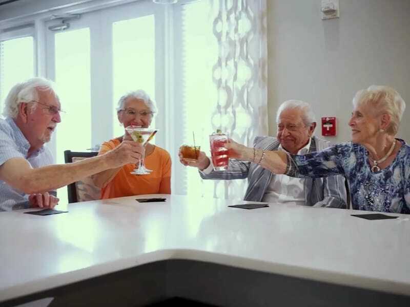 Residents toasting drinks in a common area