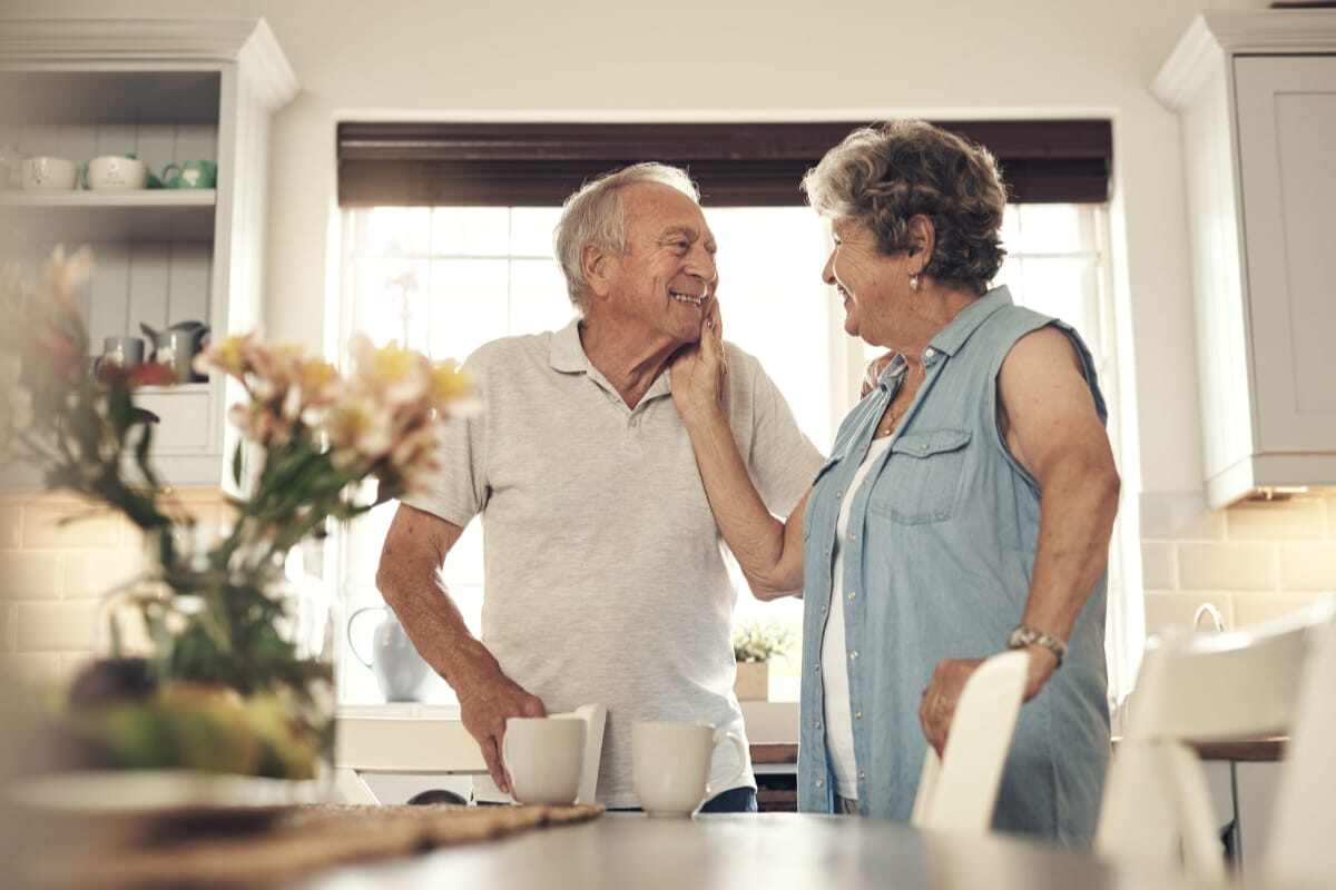 Seniors enjoying each other's company in a bright kitchen