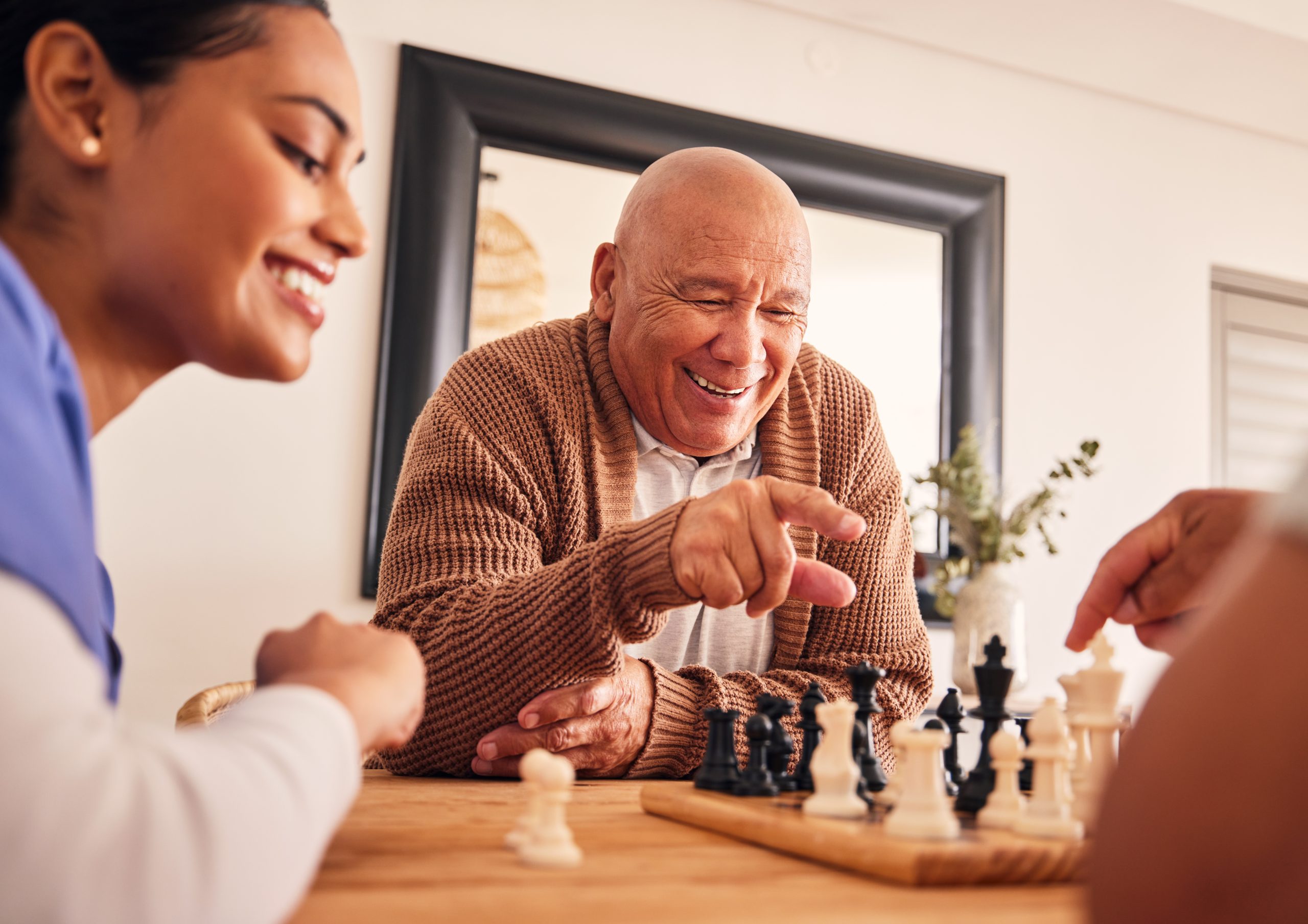 Residents and staff enjoying a game of chess