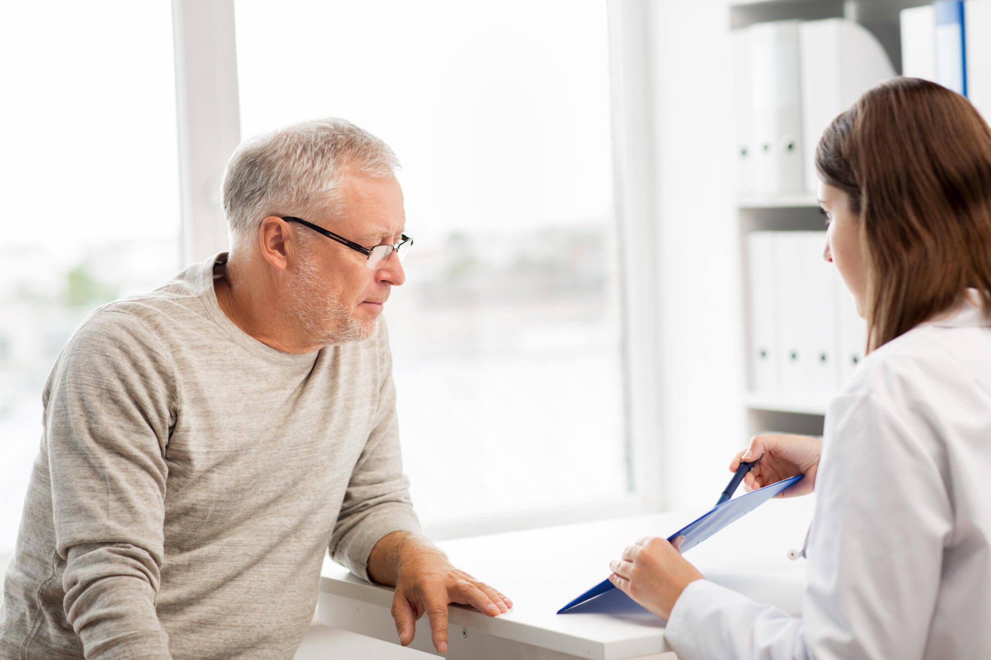 A senior man in consultation with a healthcare provider