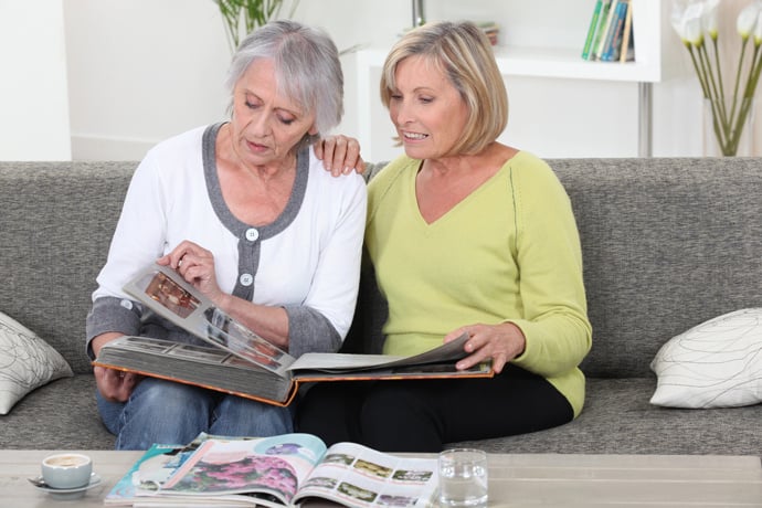 Two women looking at photo albums together