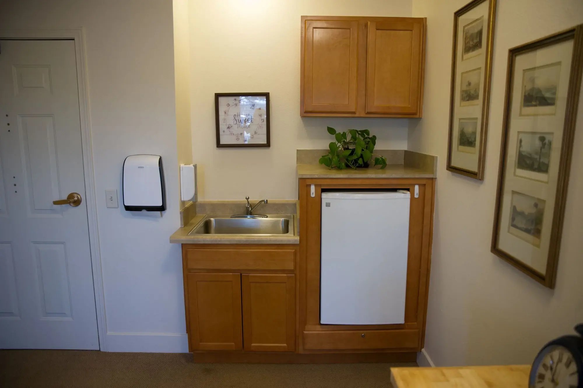 Kitchenette area with cabinets and sink