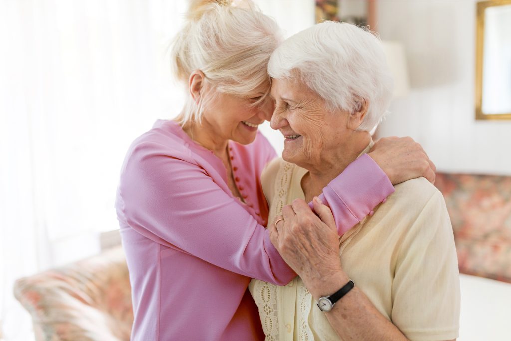 A caregiver and a resident sharing a joyful moment