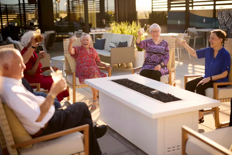 Residents enjoying drinks in an outdoor lounge area