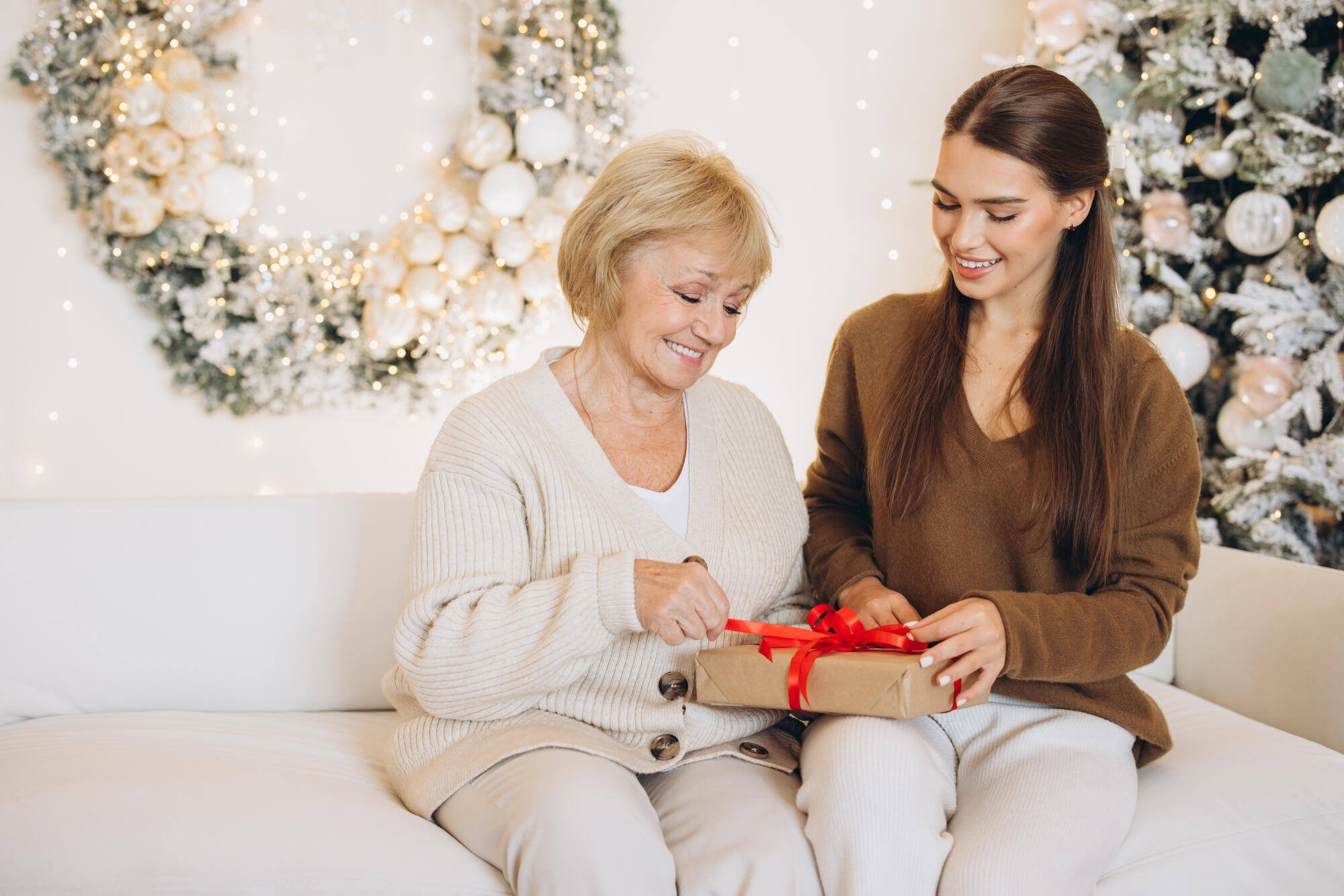 Senior resident and visitor exchanging a gift