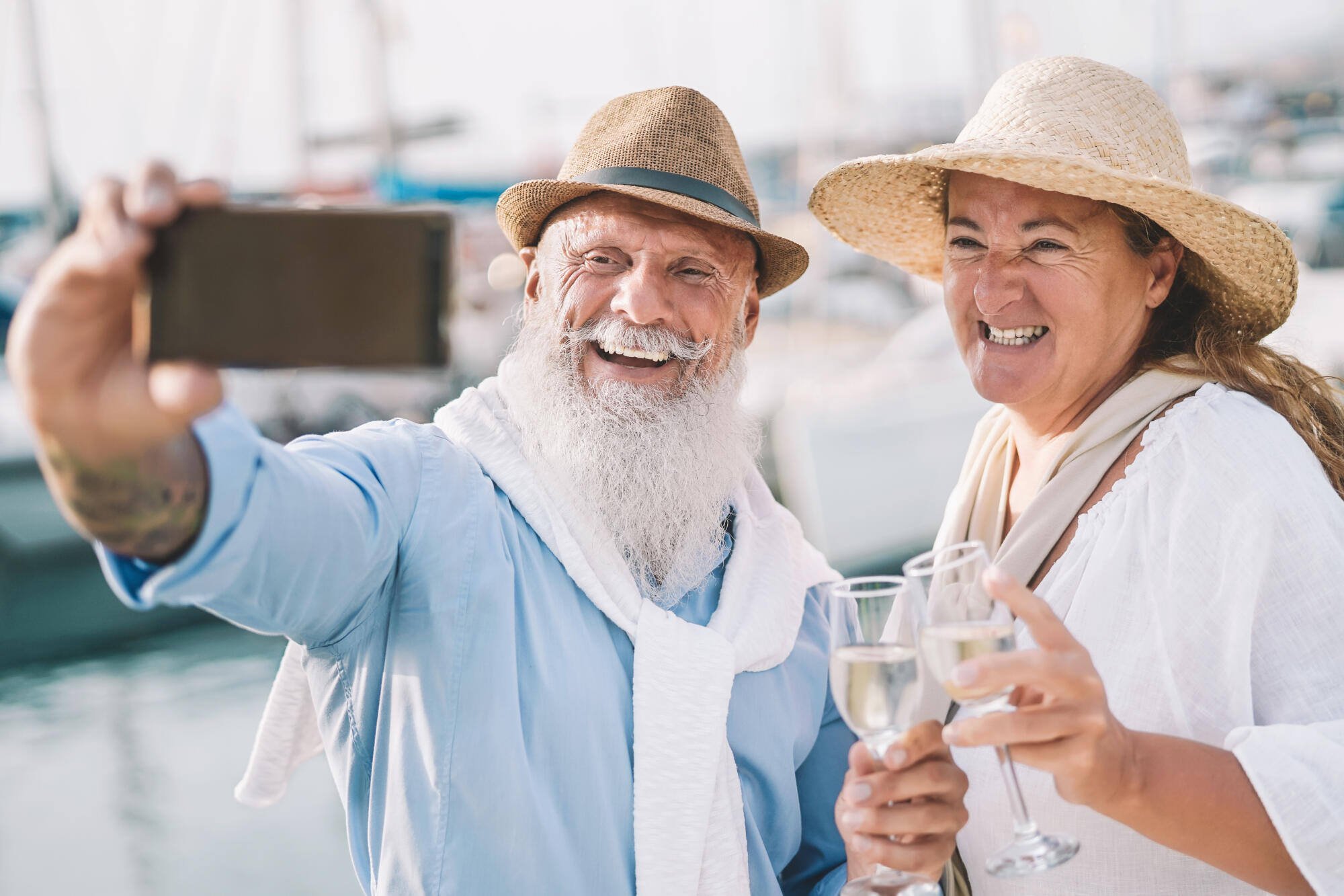 Elderly couple taking a selfie with drinks