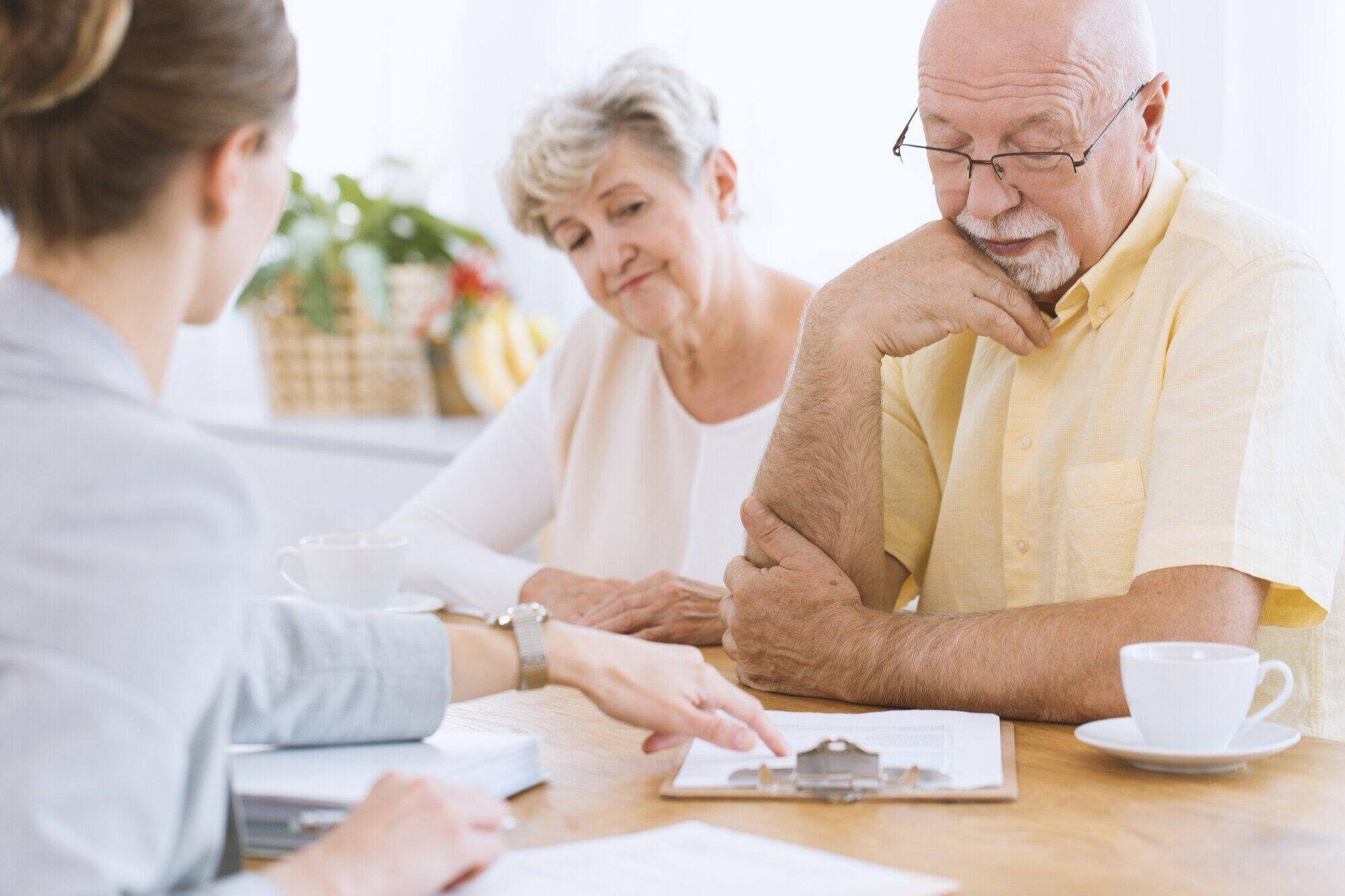 Seniors discussing with staff at a table