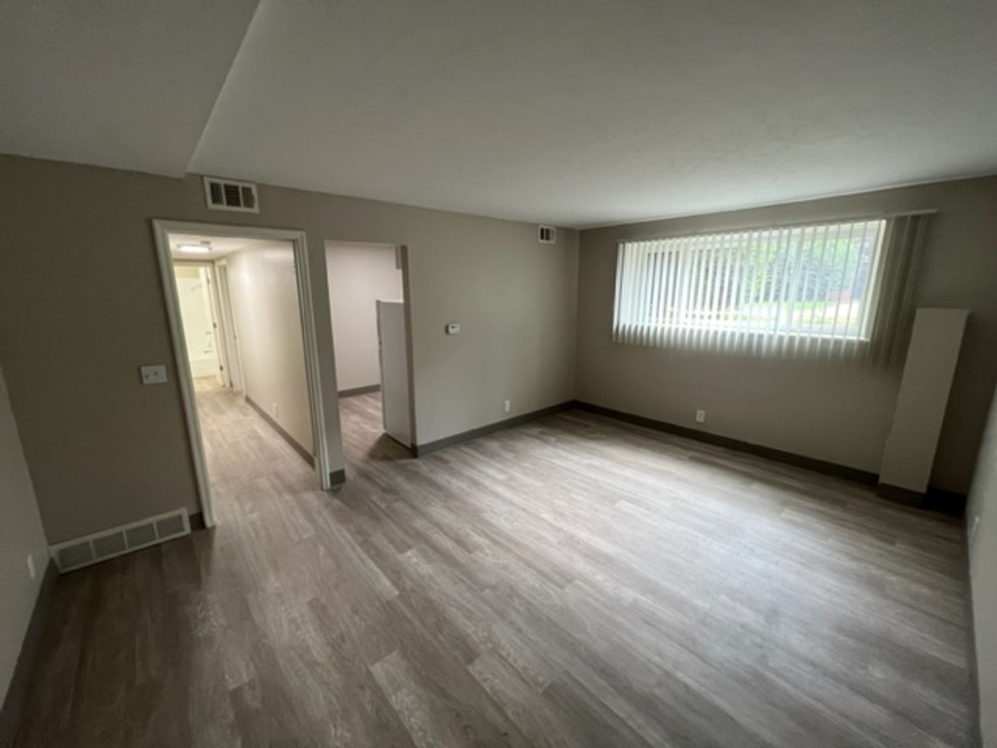 Empty interior room with light-colored walls and flooring