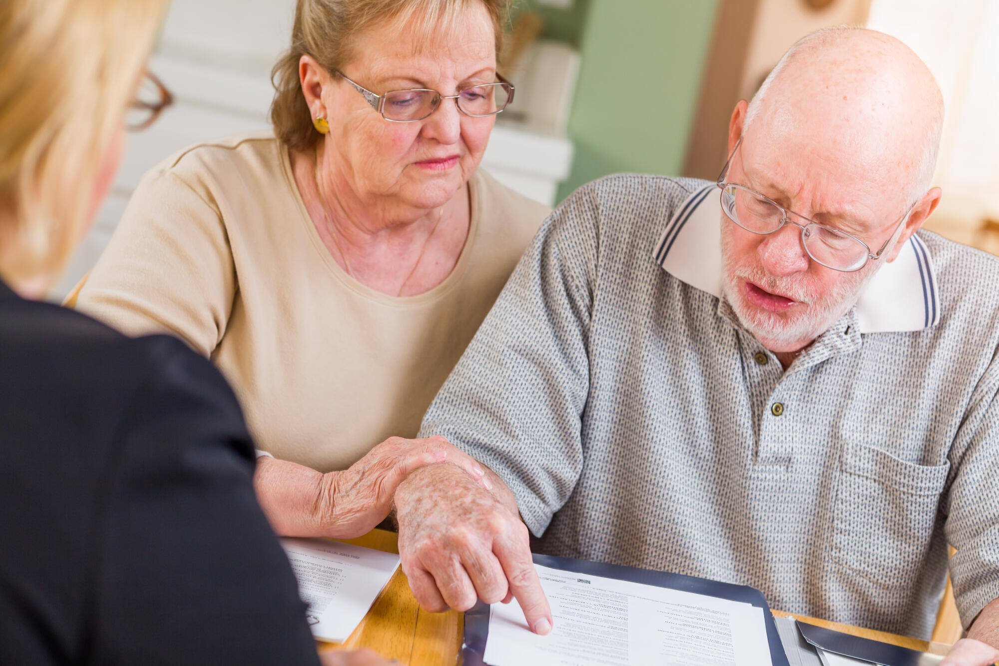 A couple reviewing documents with a staff member