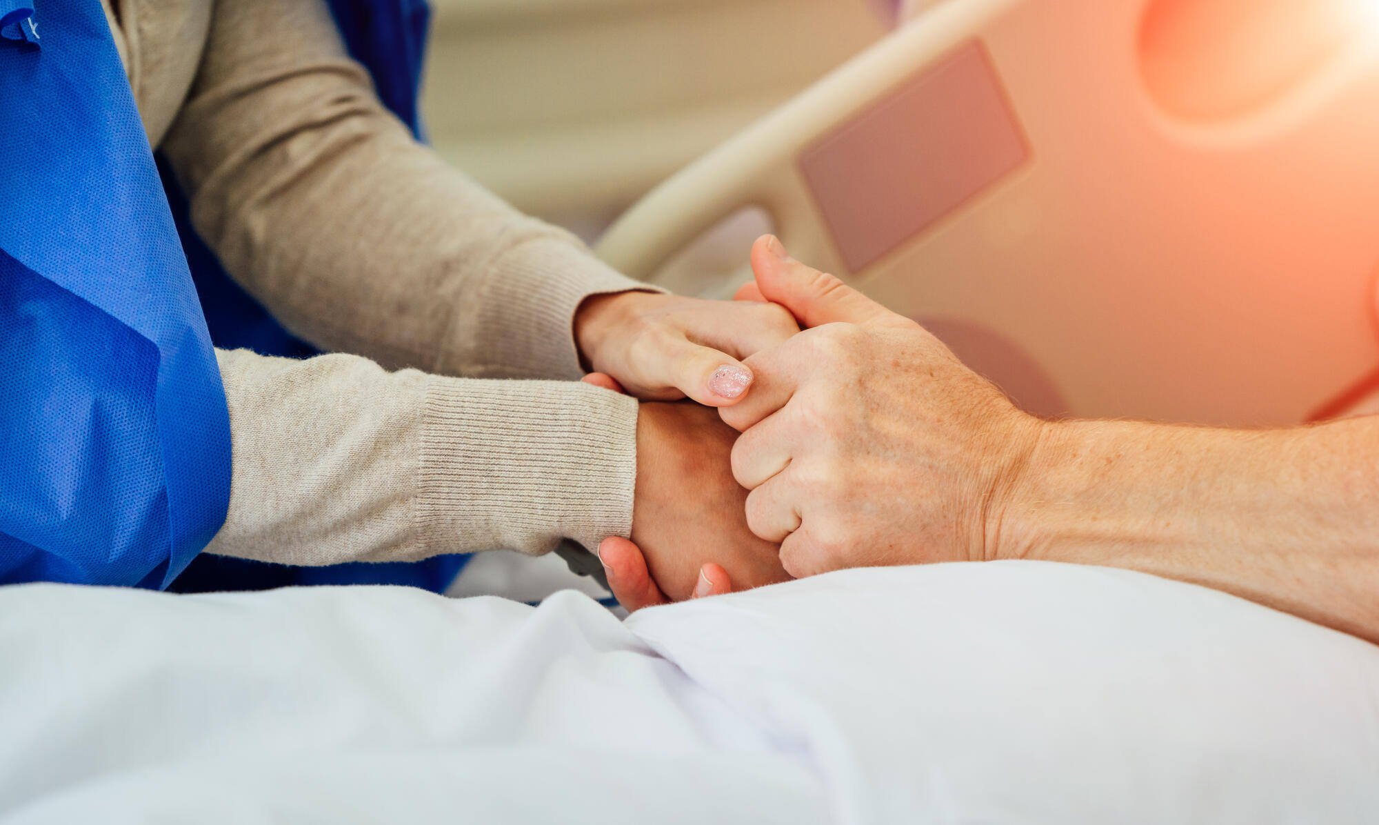 Two hands holding each other in a caring gesture