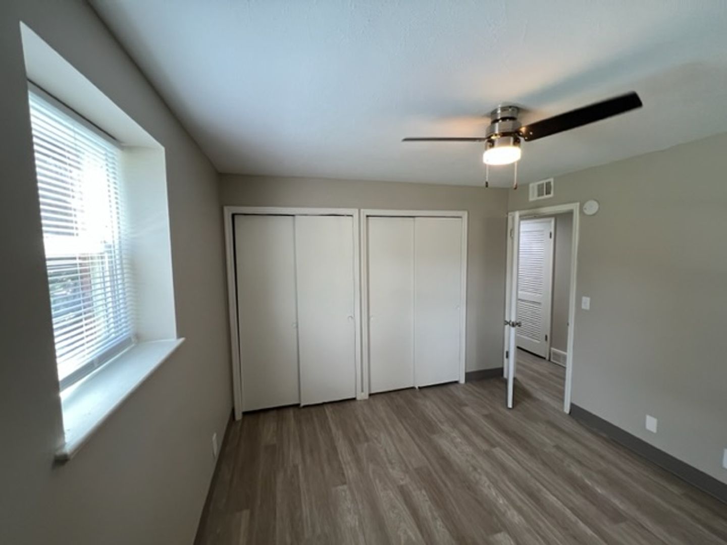 A private room with wooden flooring and windows