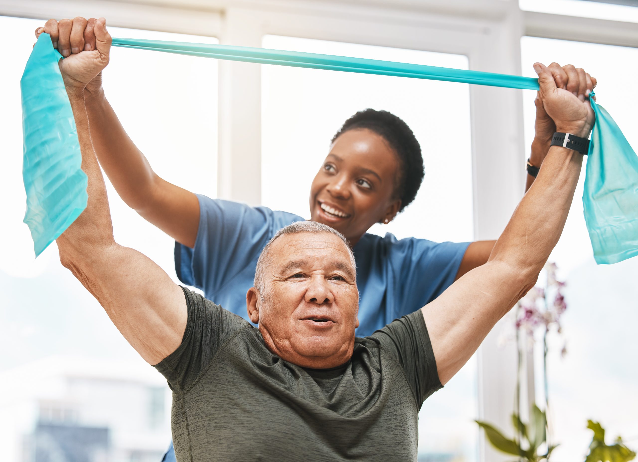 A therapist assisting a senior with exercise