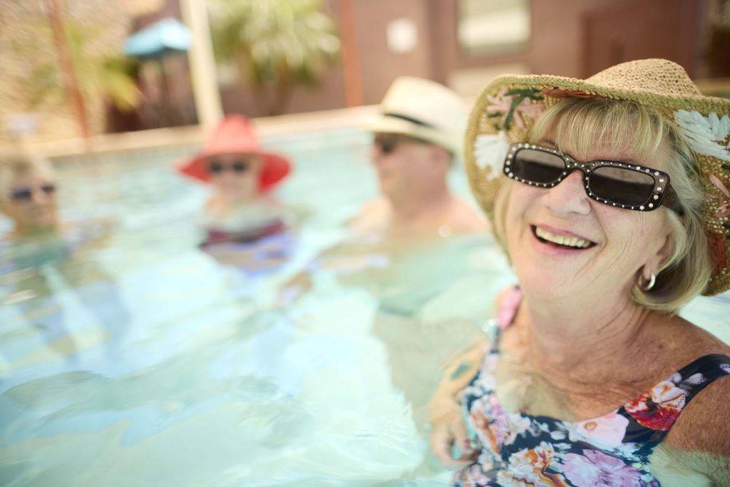 Residents enjoying a swimming pool on a sunny day
