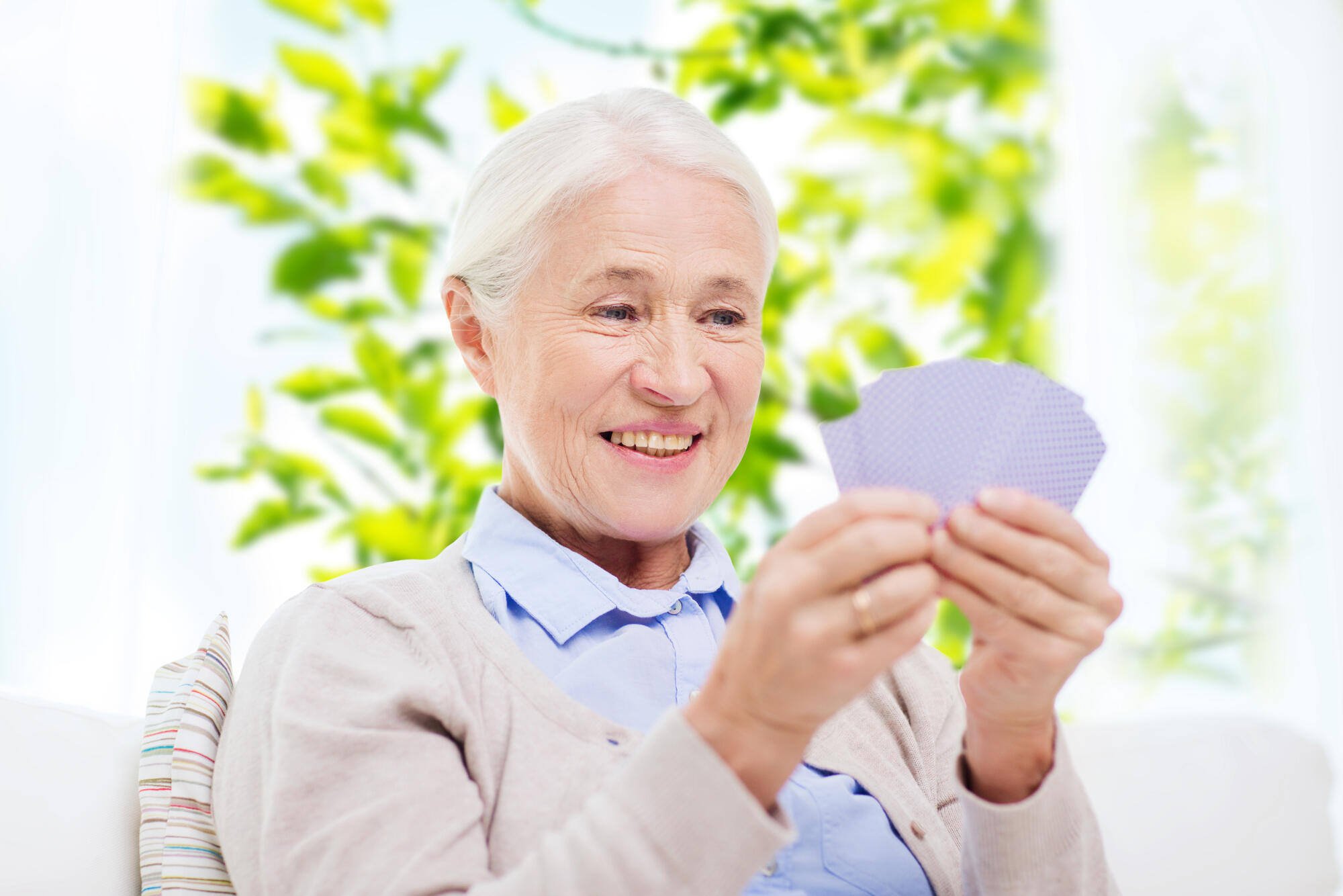 Senior resident enjoying a card game indoors