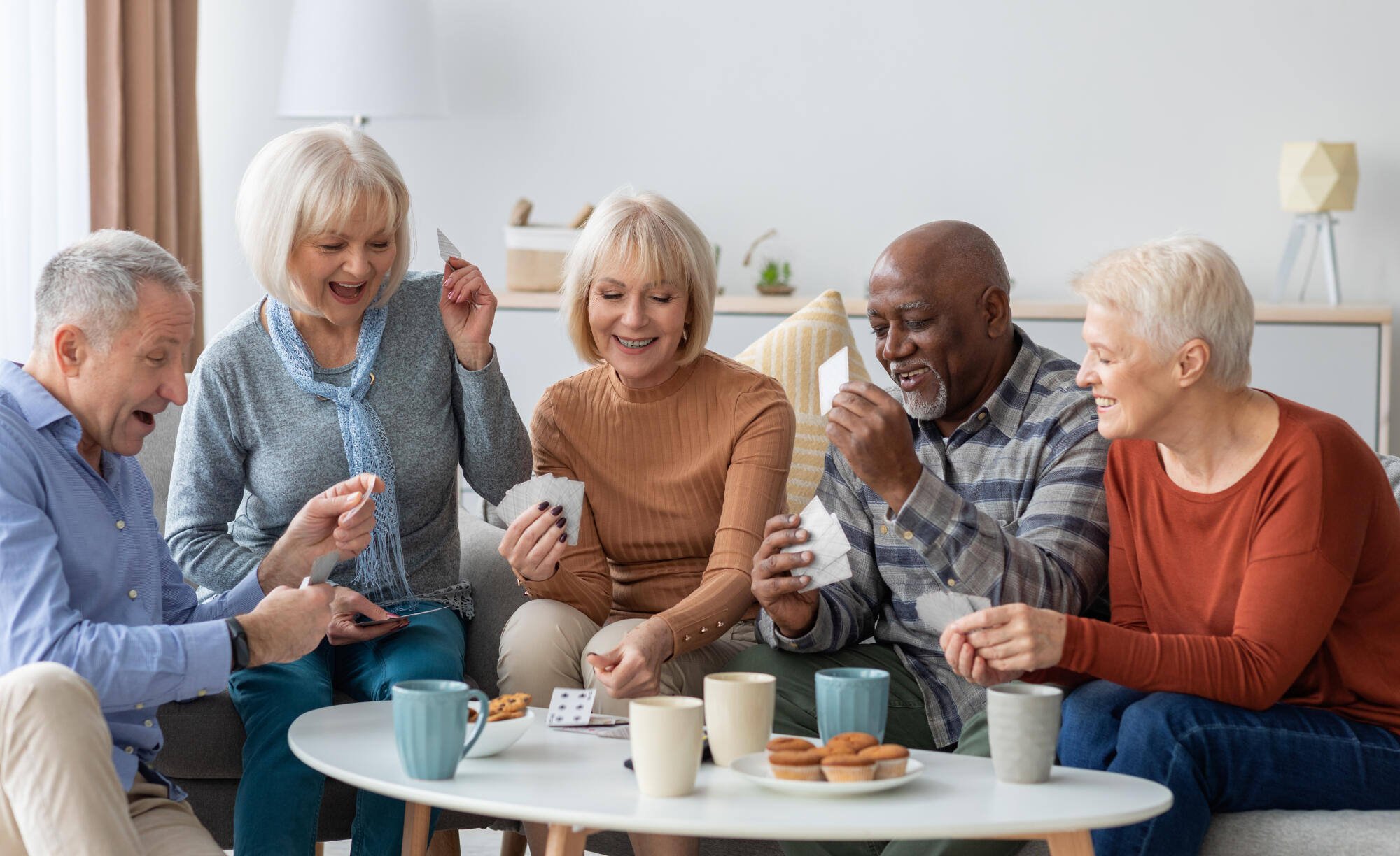 Residents enjoying a card game in a common area