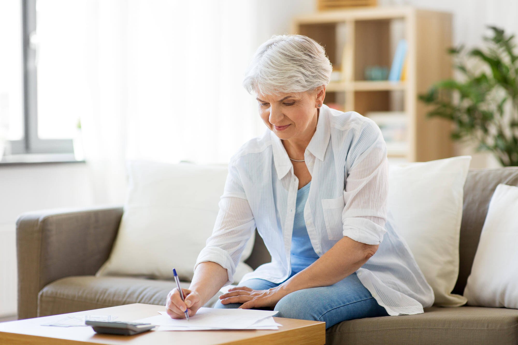 Resident working on paperwork in a cozy living area