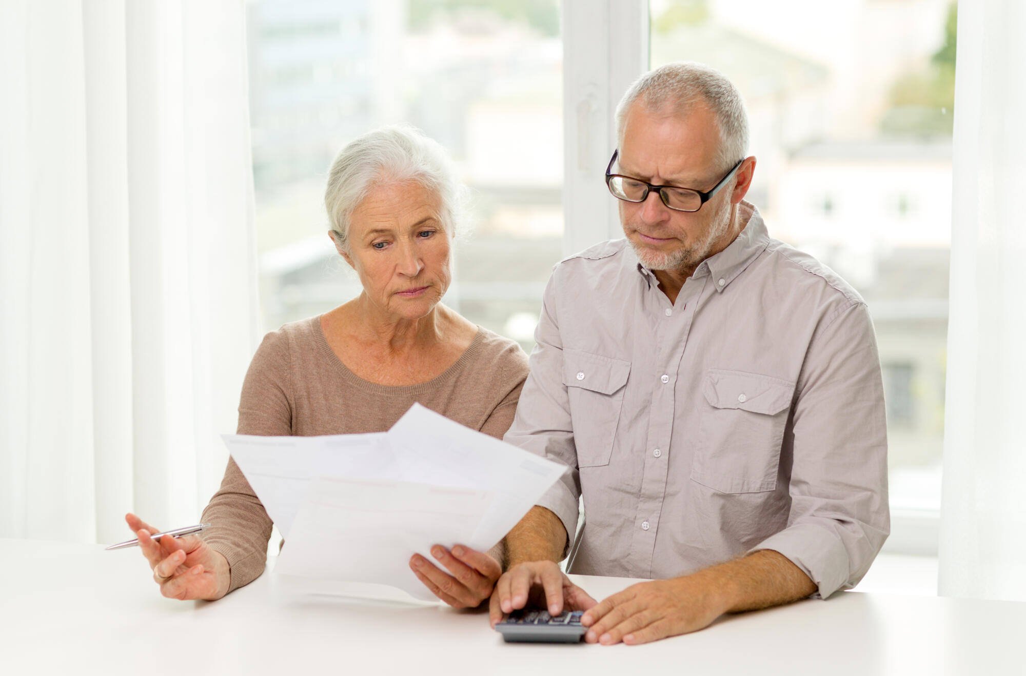 A senior couple reviewing documents at a table