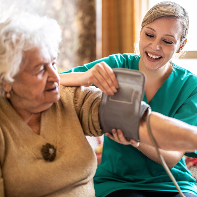 Healthcare staff checking a resident's blood pressure