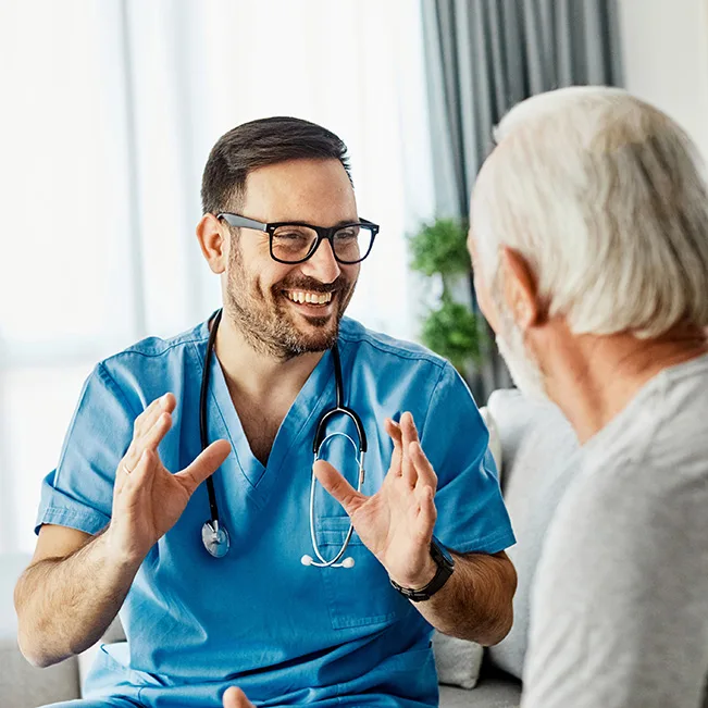 Healthcare professional engaging with a senior resident