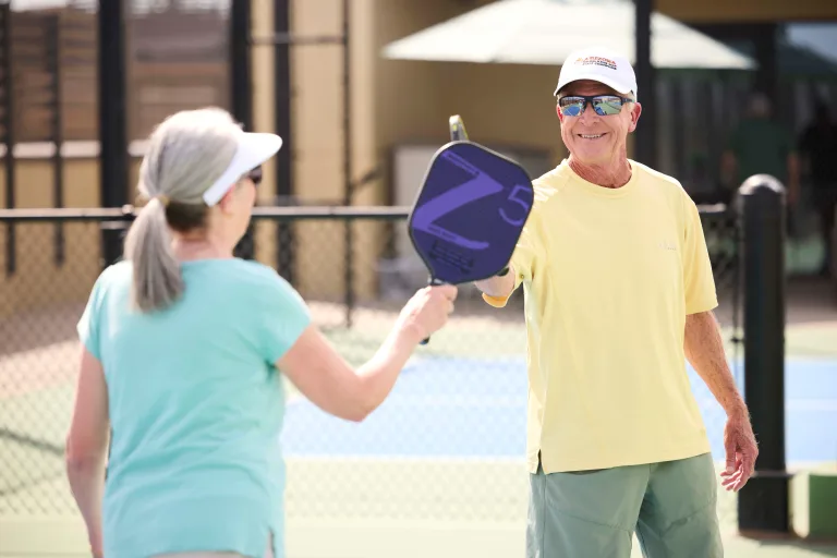 Residents playing pickleball outdoors