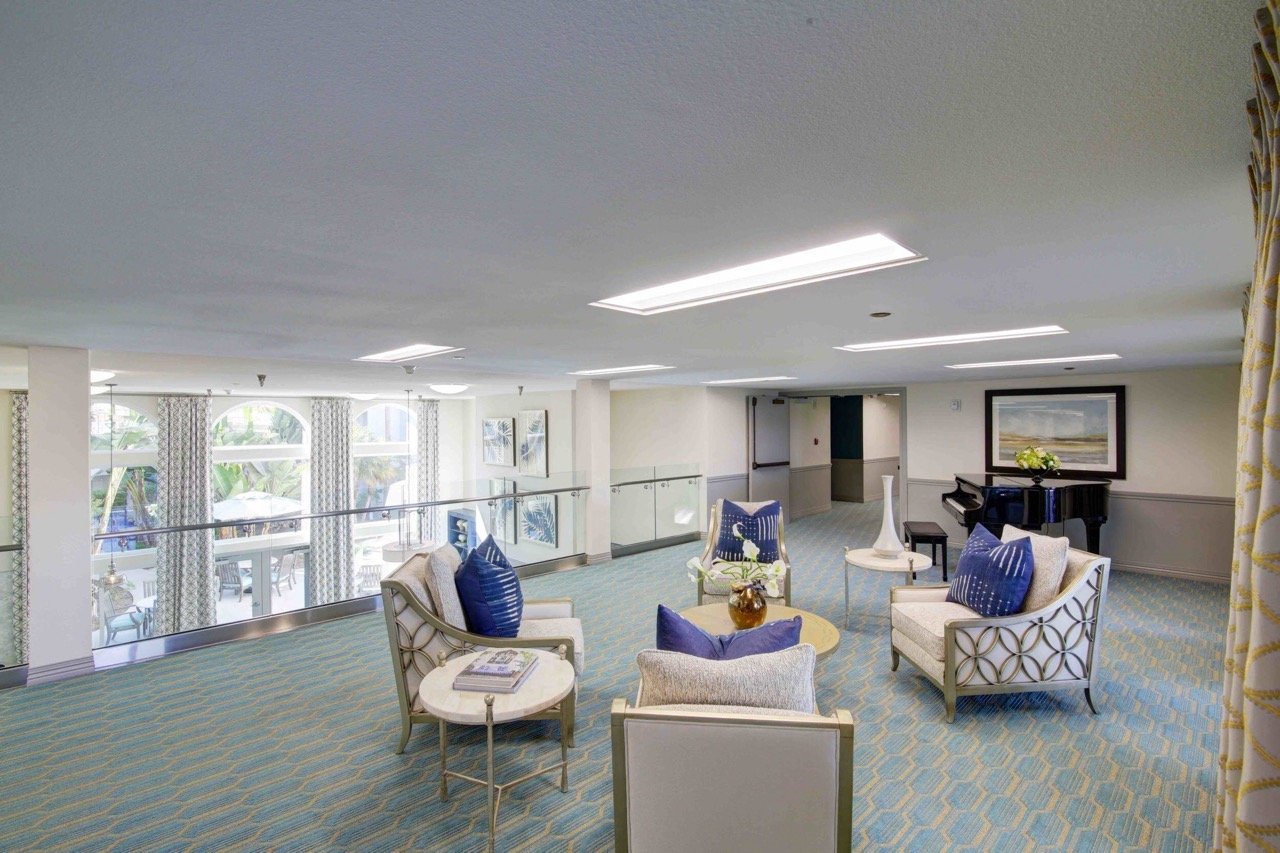 Bright common area with comfortable seating and piano