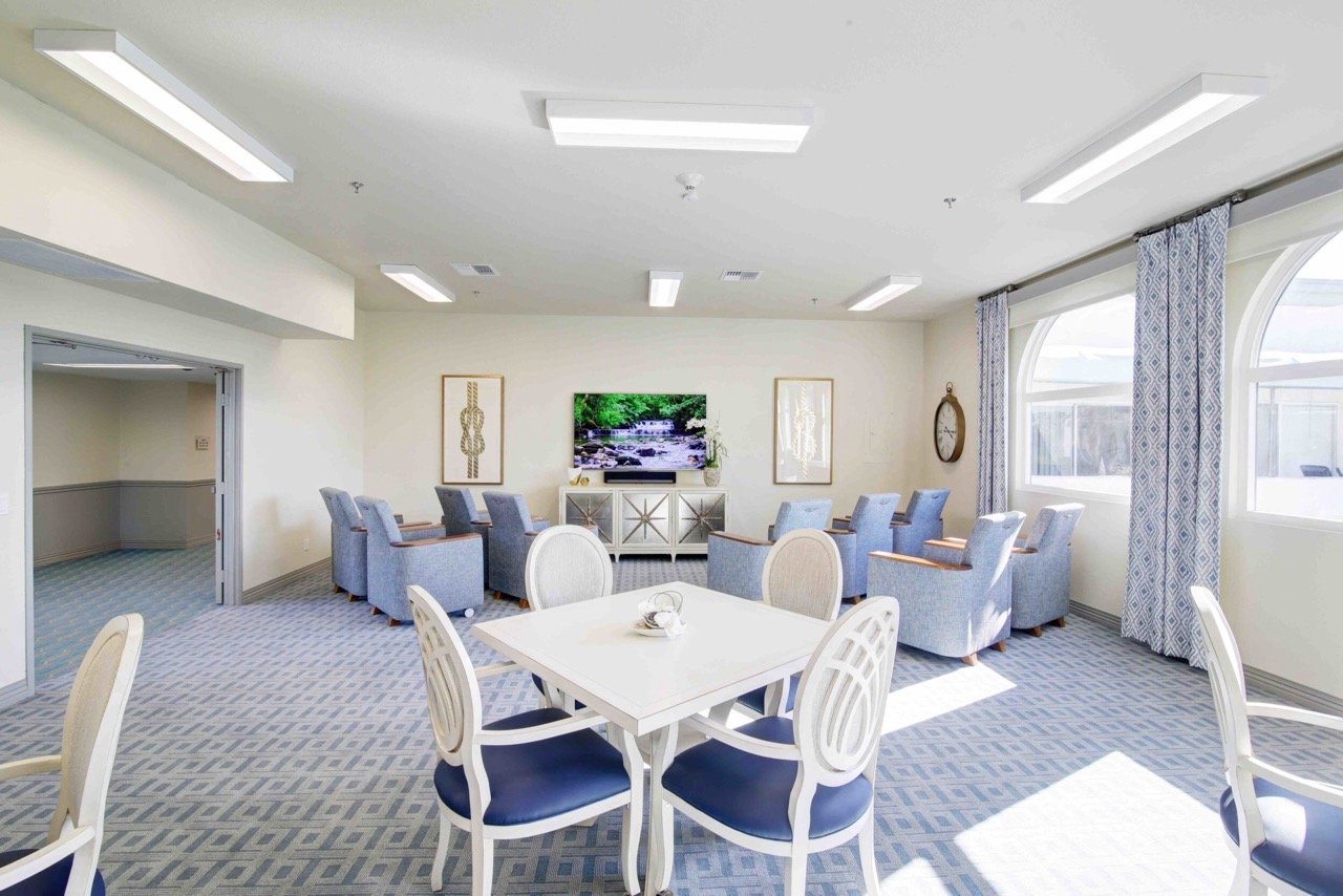 Common area with seating and television in a bright room