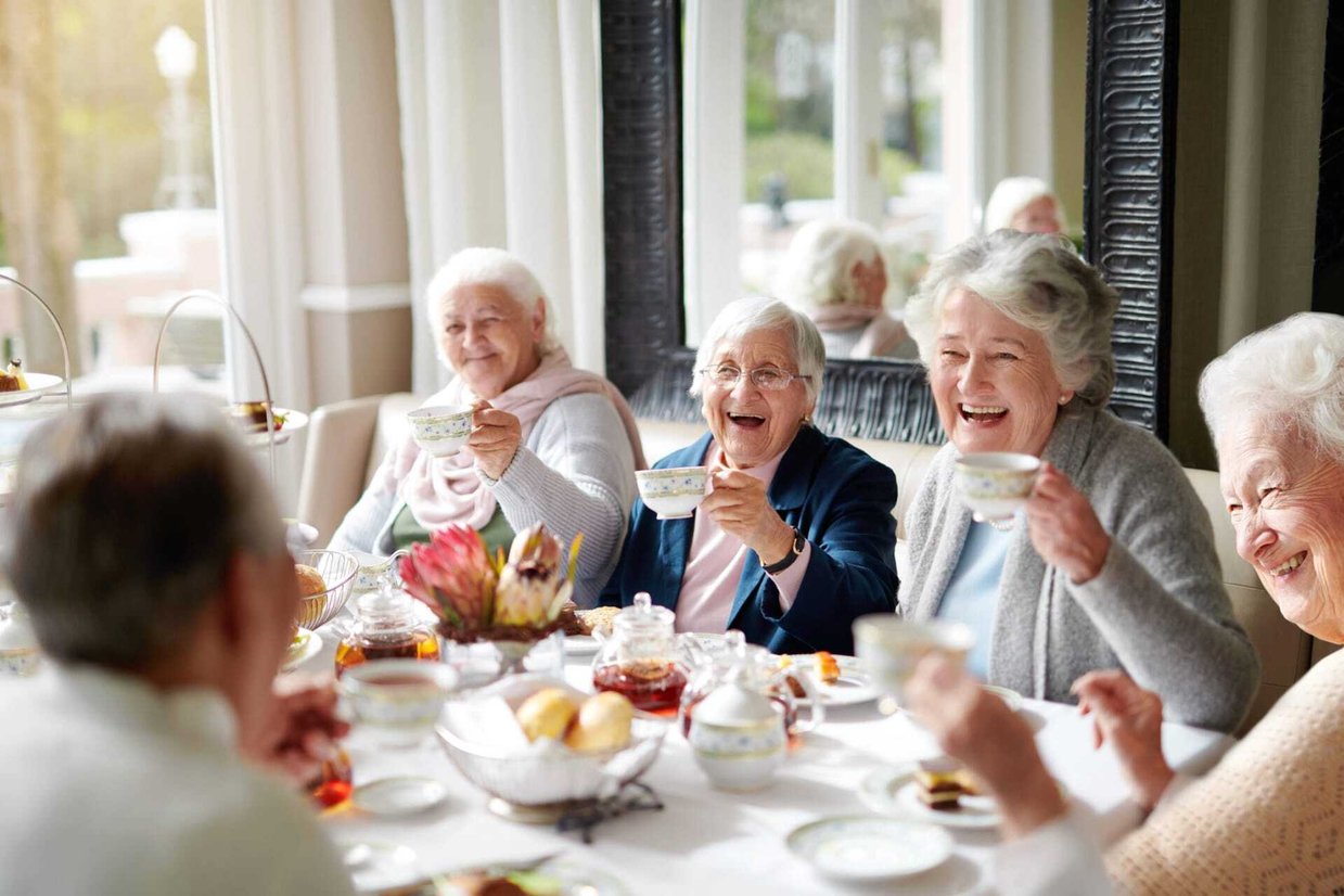 Residents enjoying tea together at a dining table