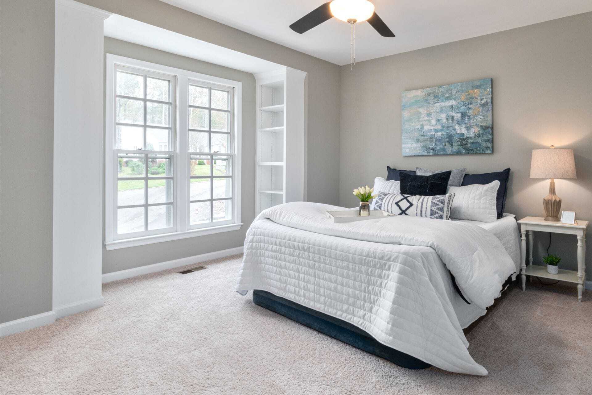 Cozy, well-decorated resident room with a bed and windows