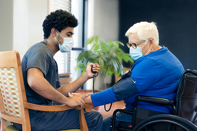 Healthcare interaction between a staff member and a resident.