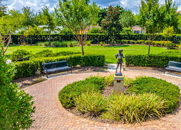 Lush outdoor garden with a sculpture and benches
