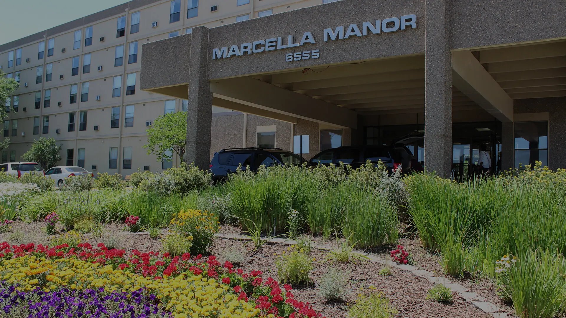 Exterior view of Marcella Manor Apartments with landscaping