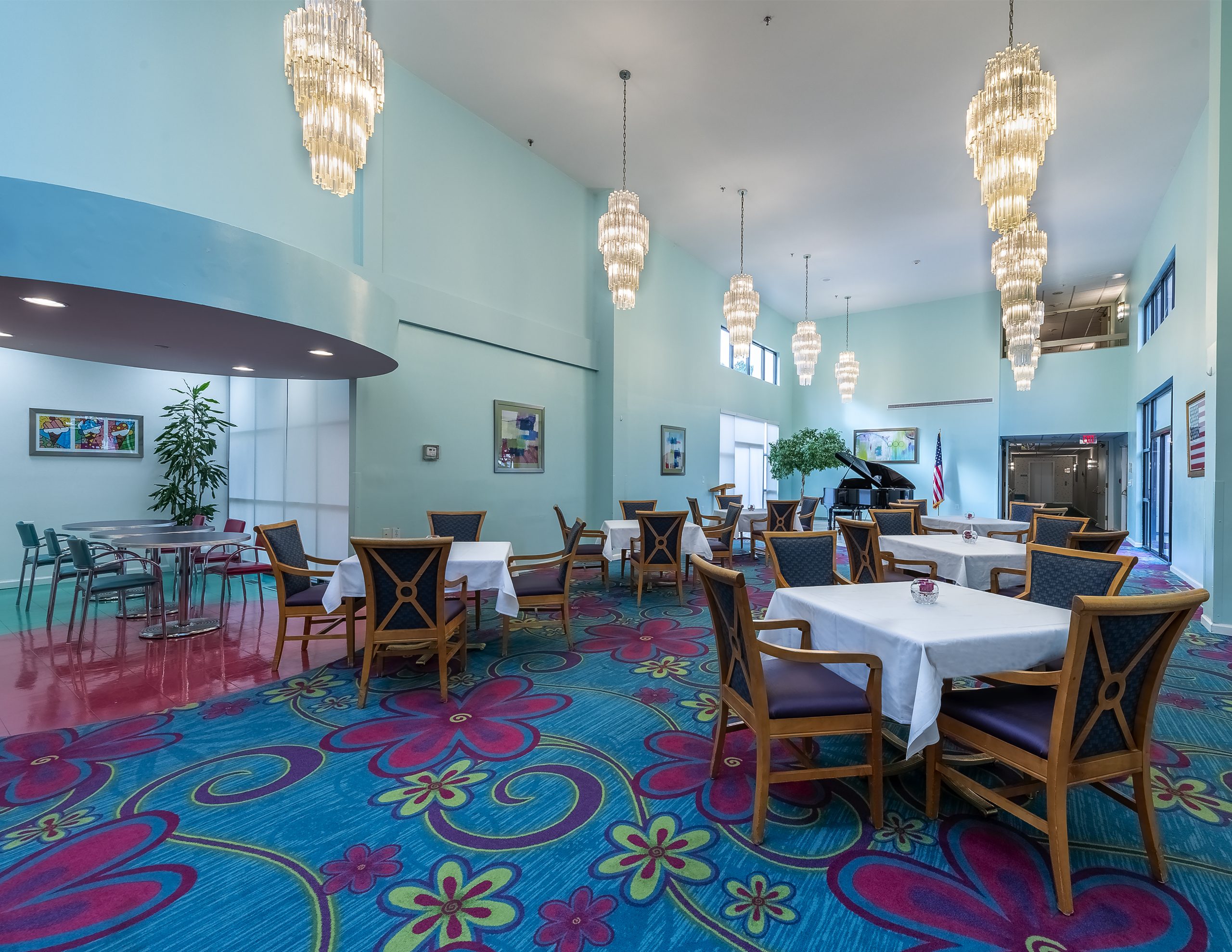 Bright dining area with colorful decor and chandeliers