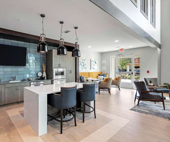 Bright, modern common area with seating and kitchen
