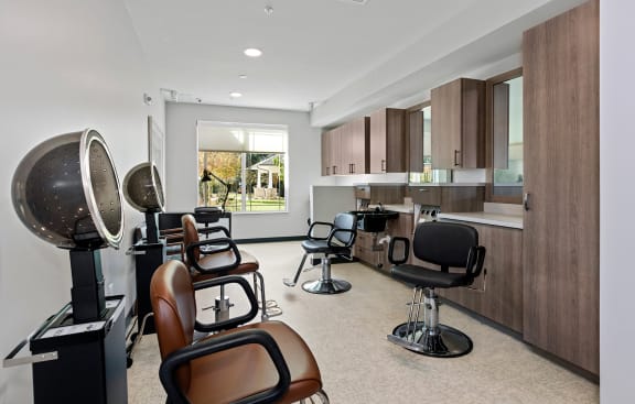 Brightly lit hair salon with styling chairs