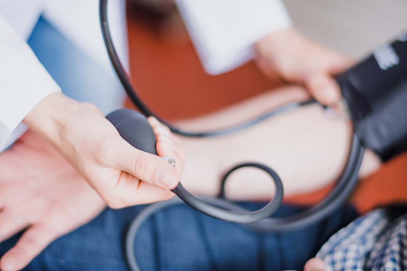 A staff member checking a resident's blood pressure