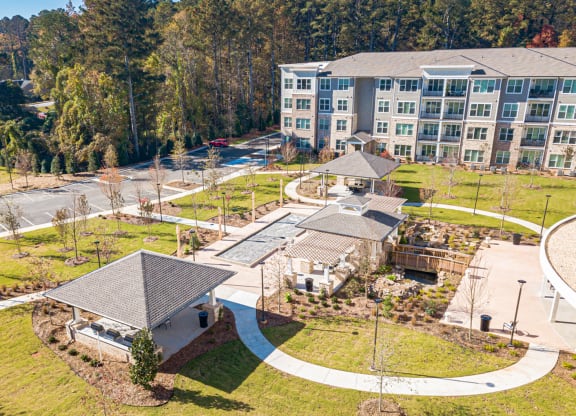 Aerial view of an assisted living facility with gardens and pathways