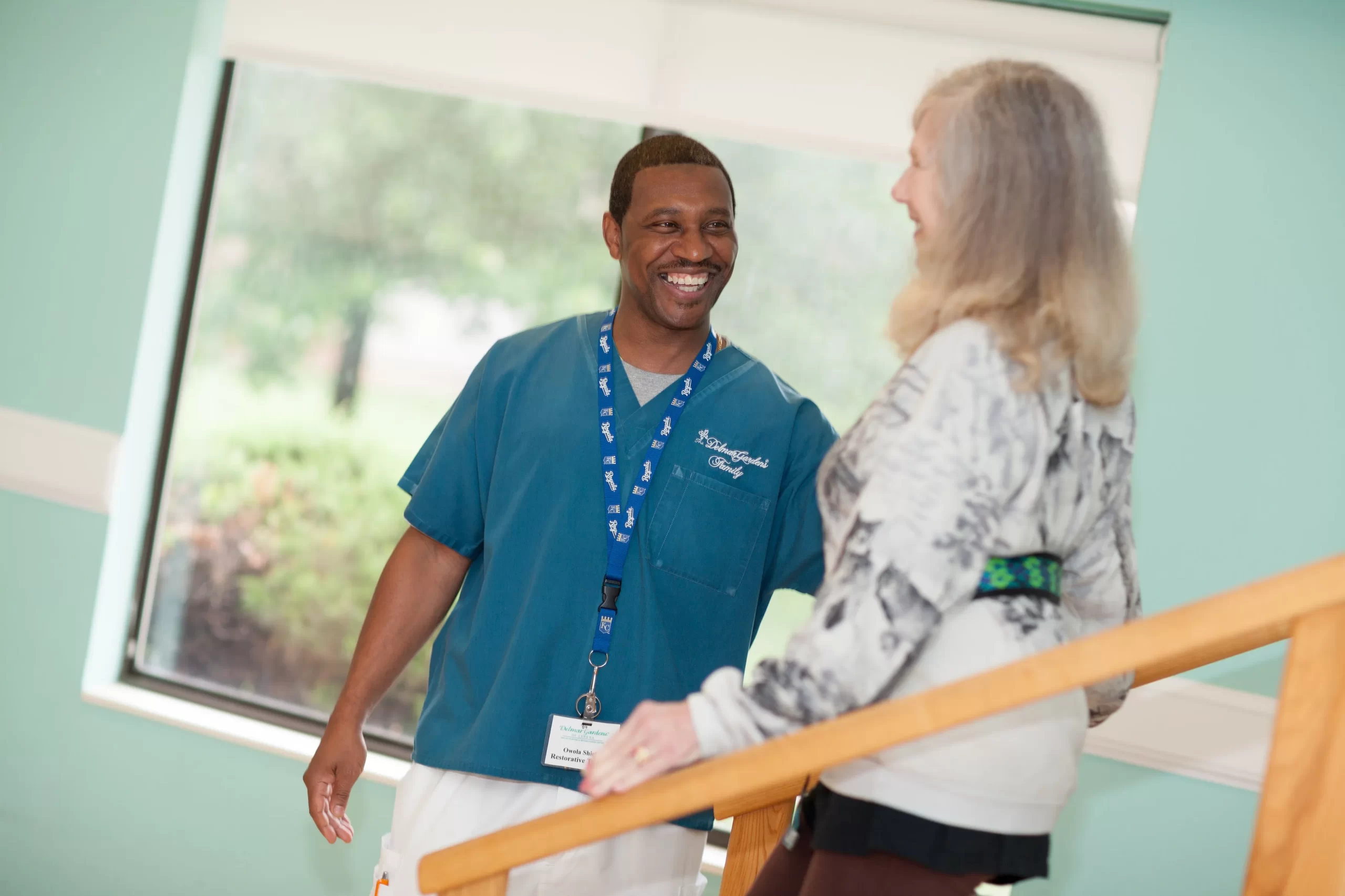 Staff assisting a resident in an interior hallway
