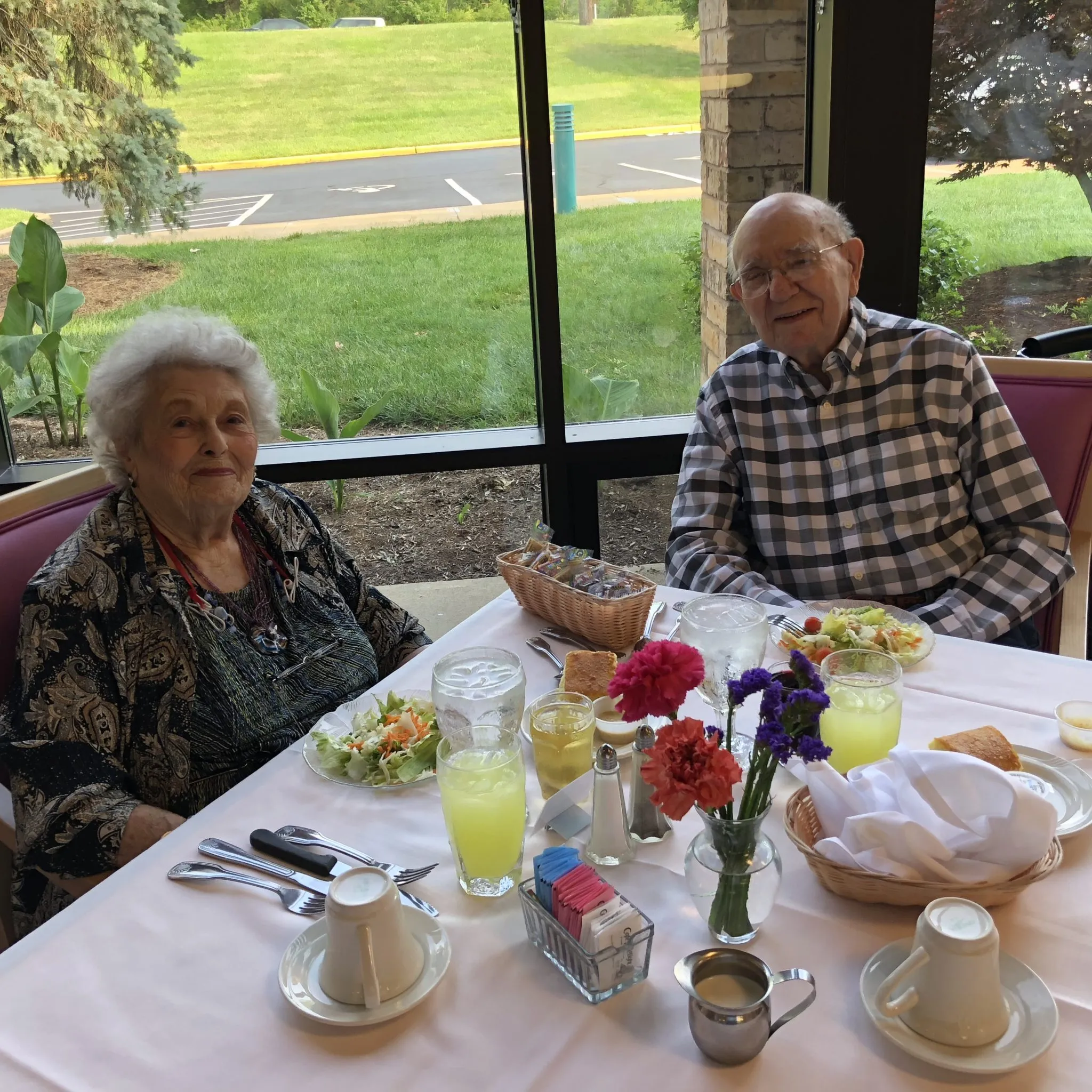 Two residents enjoying a meal at a dining table