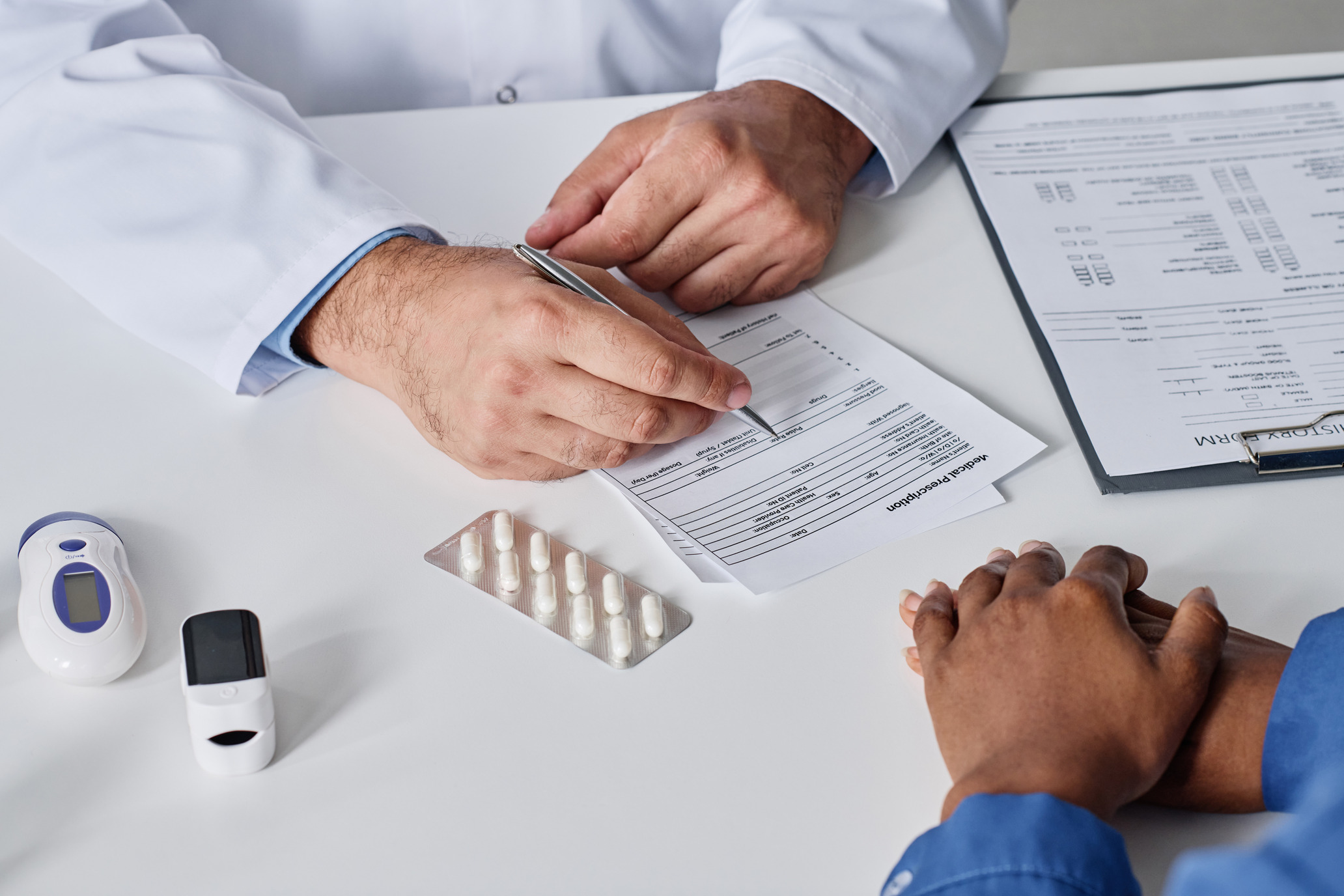 A healthcare professional filling out forms with a patient