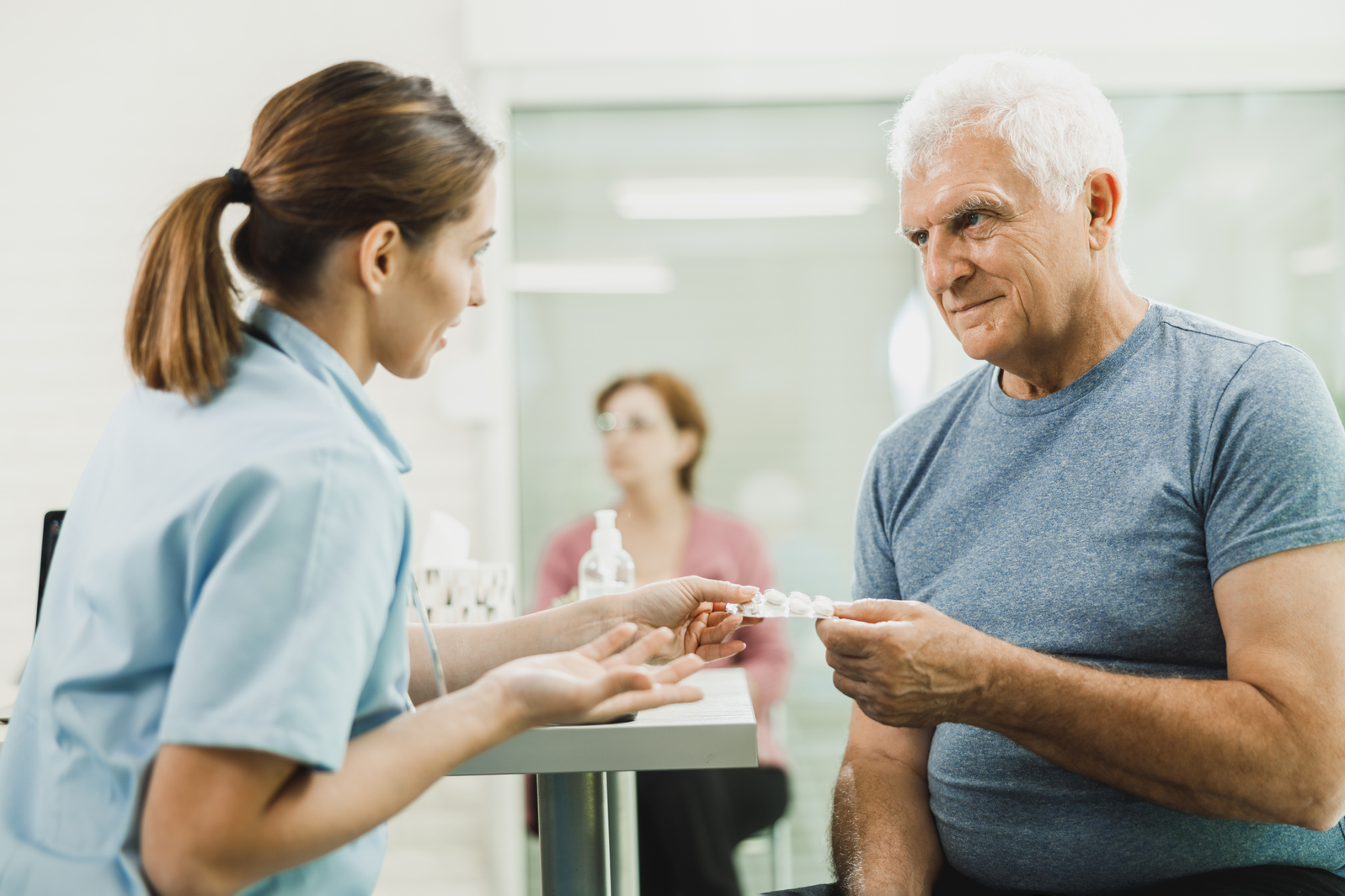 A caregiver talking with a senior resident in a care setting