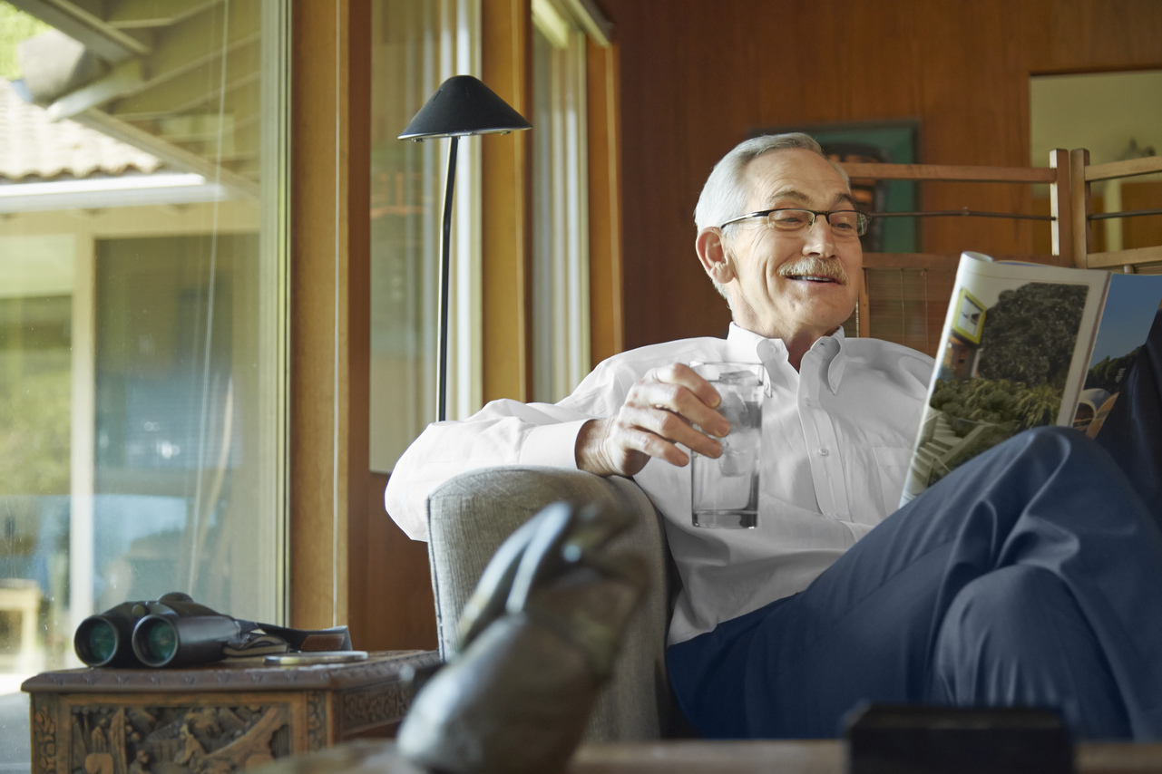 Senior man enjoying a magazine in a cozy room